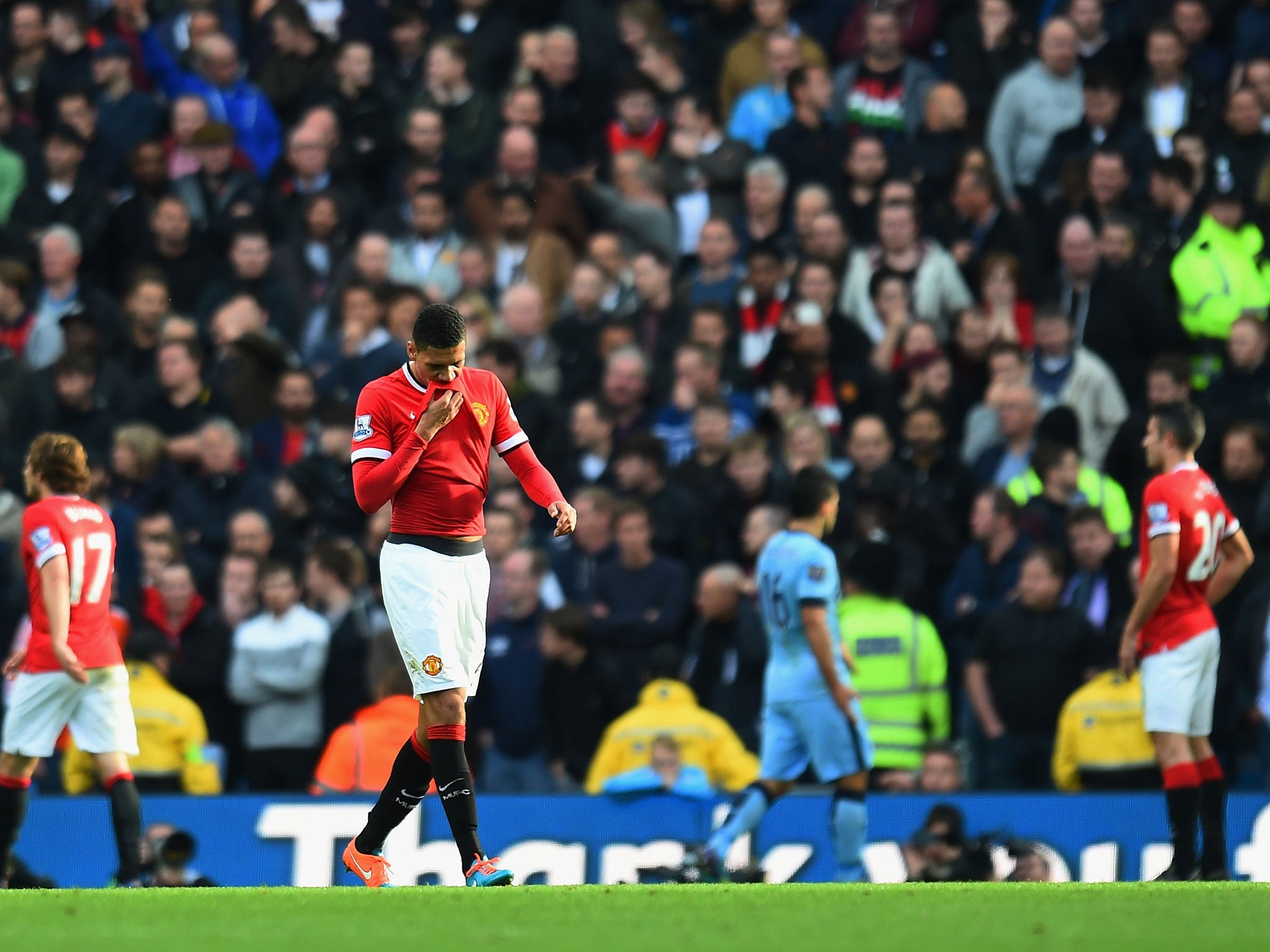 Chris Smalling walks off the pitch after being sent-off during the Manchester derby defeat to Manchester City