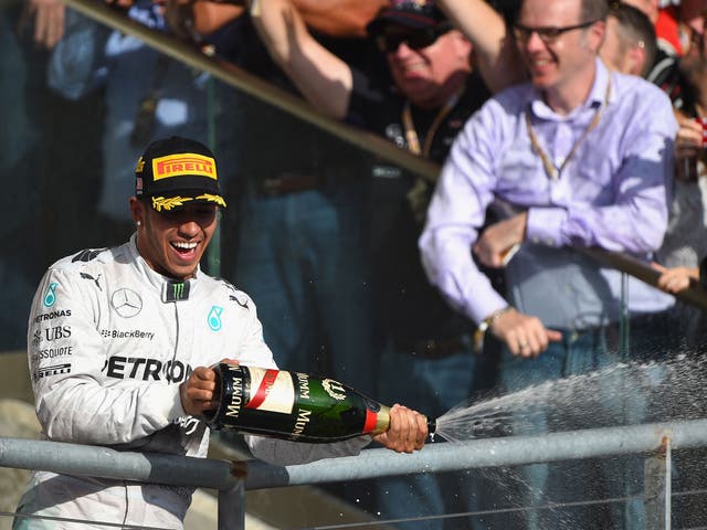 Lewis Hamilton celebrates on the podium after his win in Austin