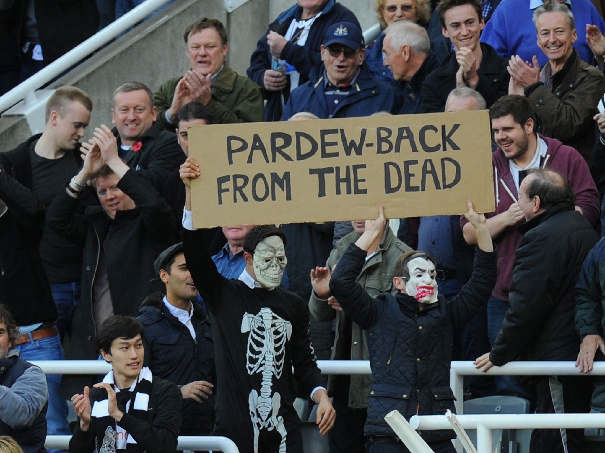 Newcastle fans hold an Alan Pardew sign