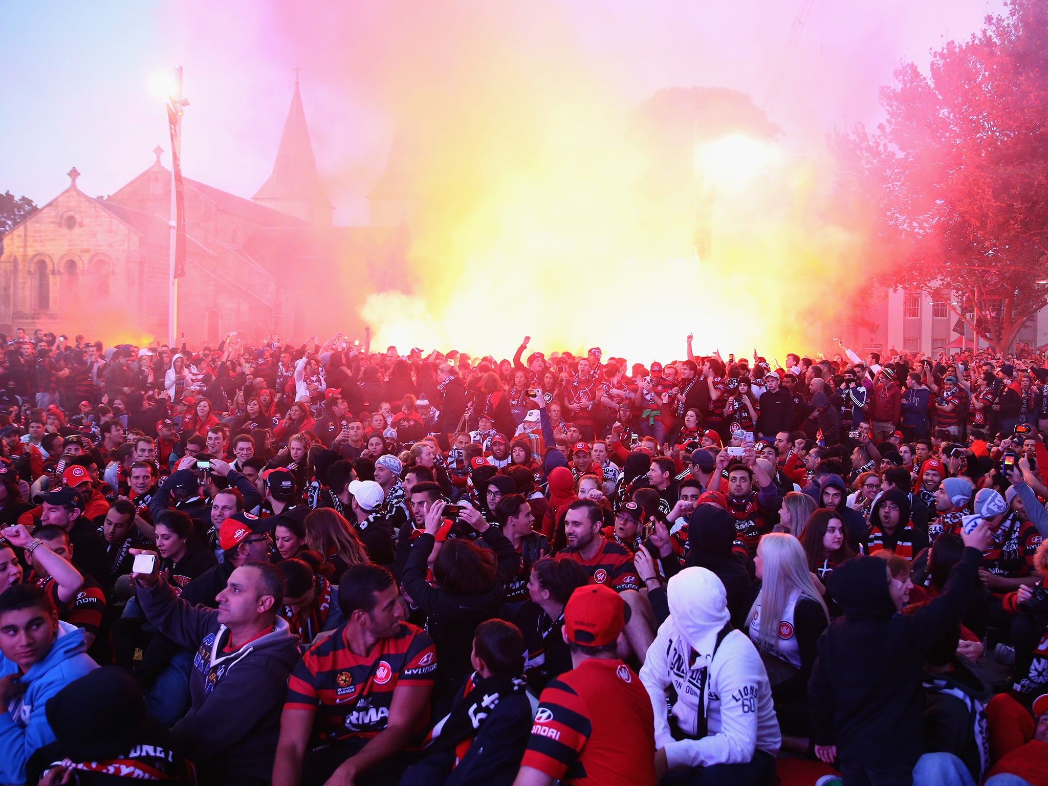 Wanderers fans light flares as they watch the Asian Champions League final match between Western Sydney Wanders and Al Hilal at Centenary Square in Parramatta