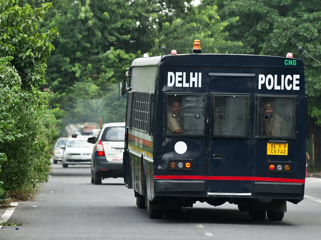 A Indian police vehicle believed to be carrying the accused in a gangrape and murder case, leaves the Saket District Court following the verdict in New Delhi on September 10, 2013. An Indian court convicted four men of the gang rape and murder of a physio