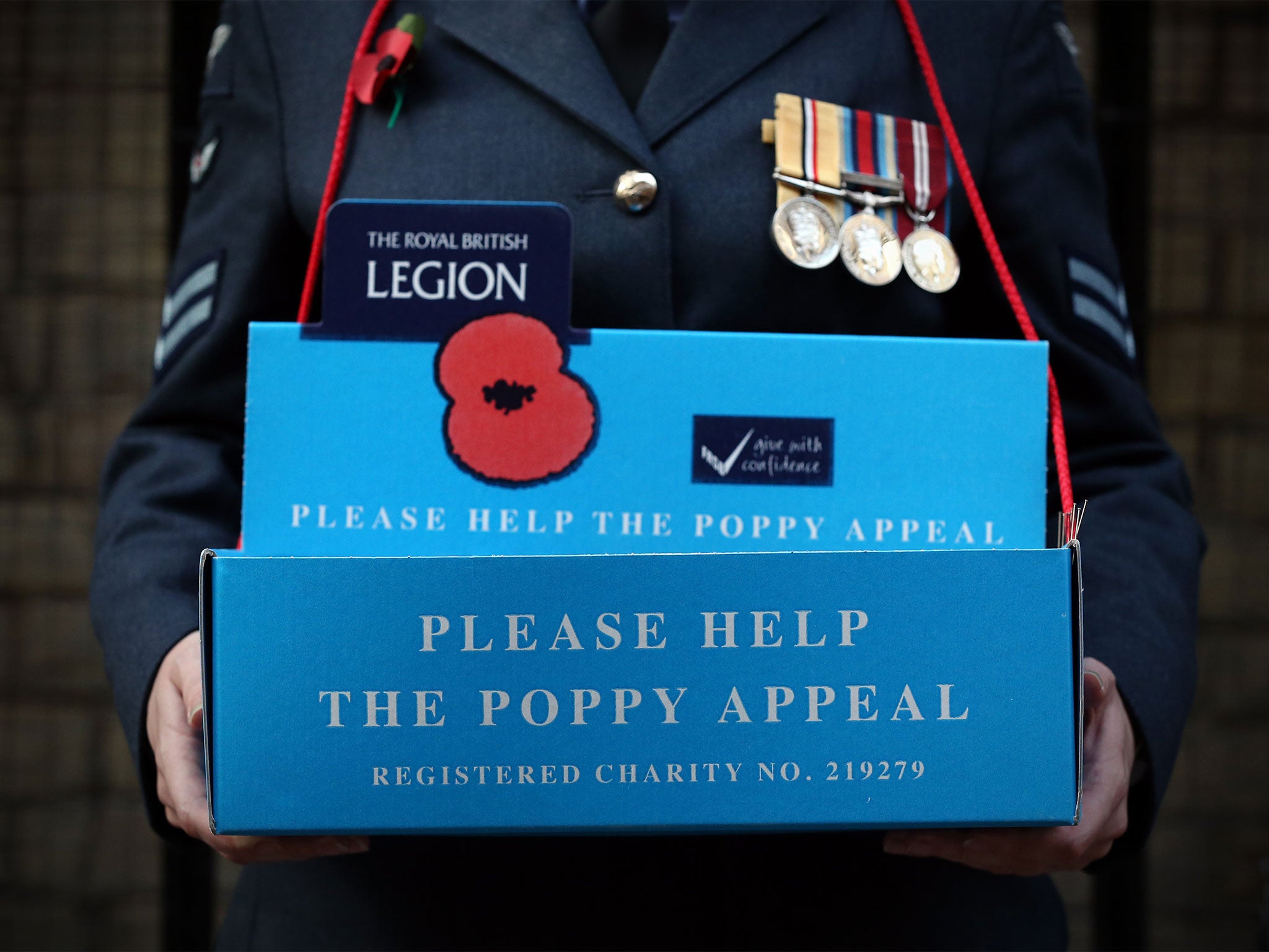 A Royal Air Force poppy appeal volunteer waits for donations
