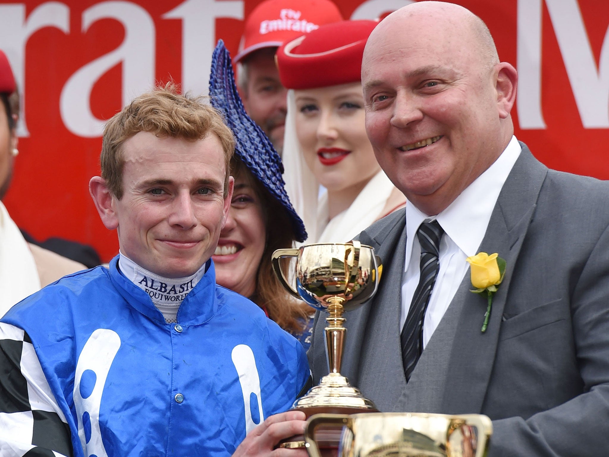 Jockey Ryan Moore collects his trophy for riding Protectionist to Melbourne Cup victory