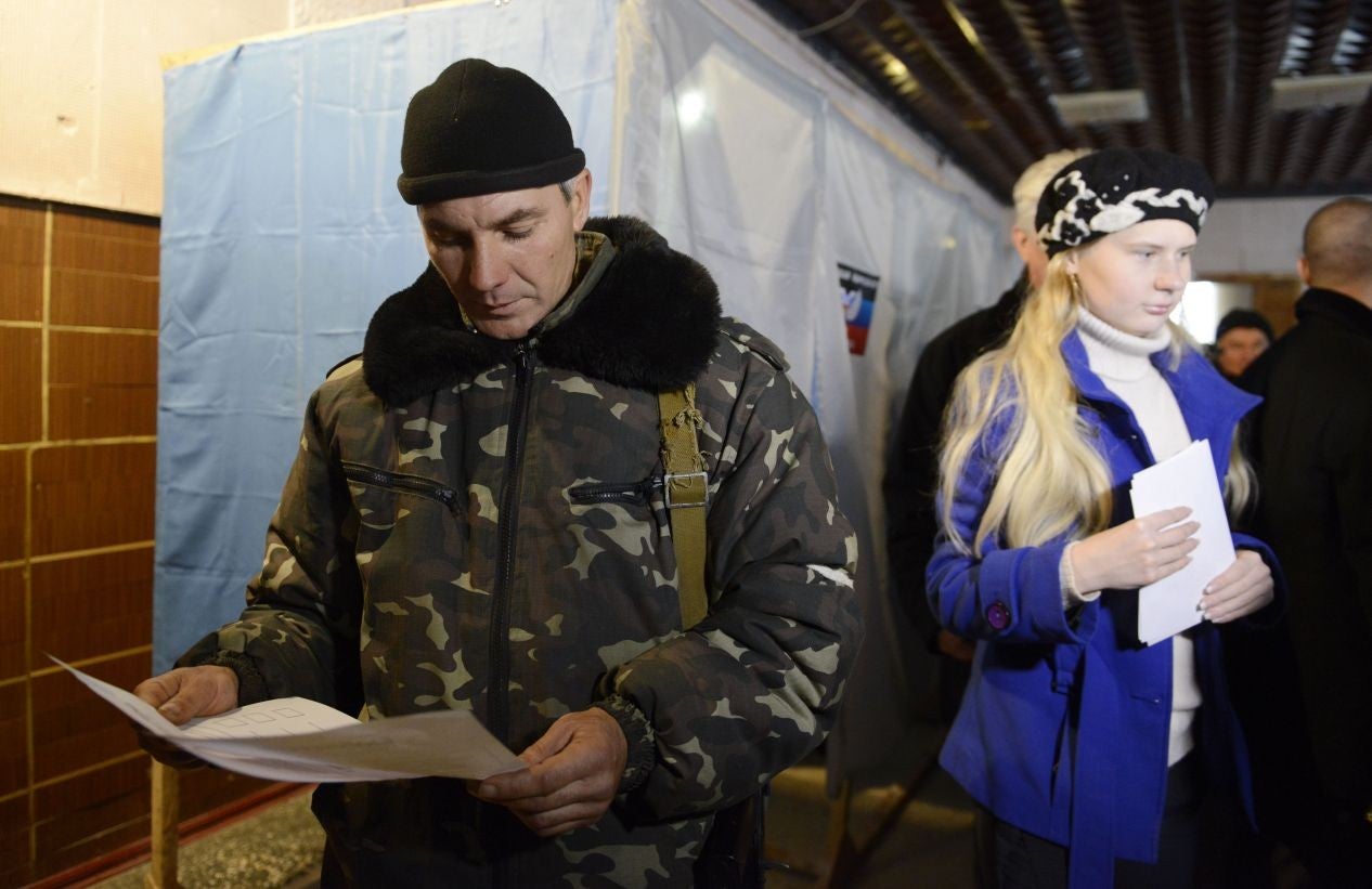 A pro-Russian militant examines his ballot during voting in polling station in Novoazovsk, Donetsk