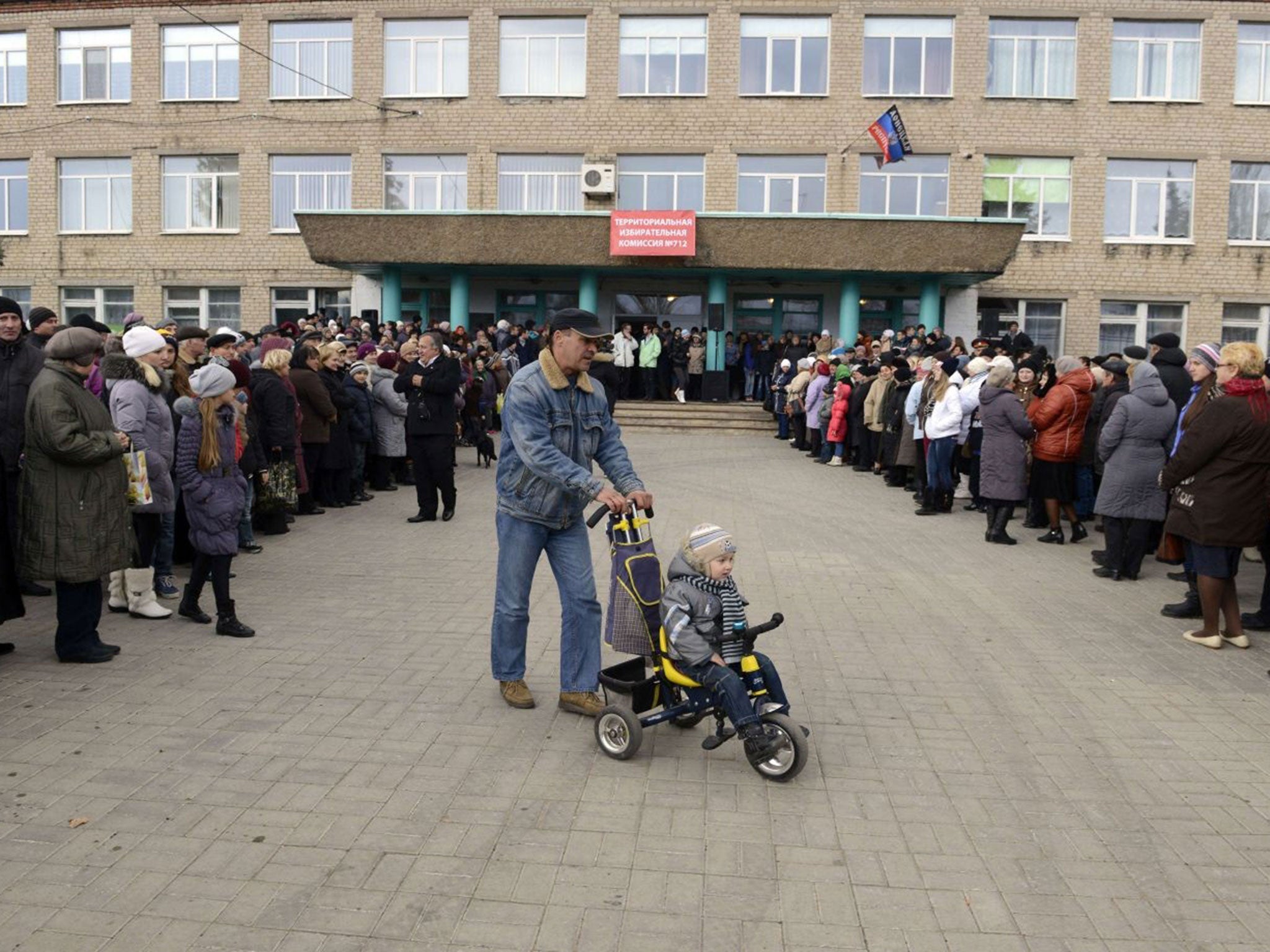 People queue to vote outside polling station in the town of Telmanove, Donetsk region, on 2 November