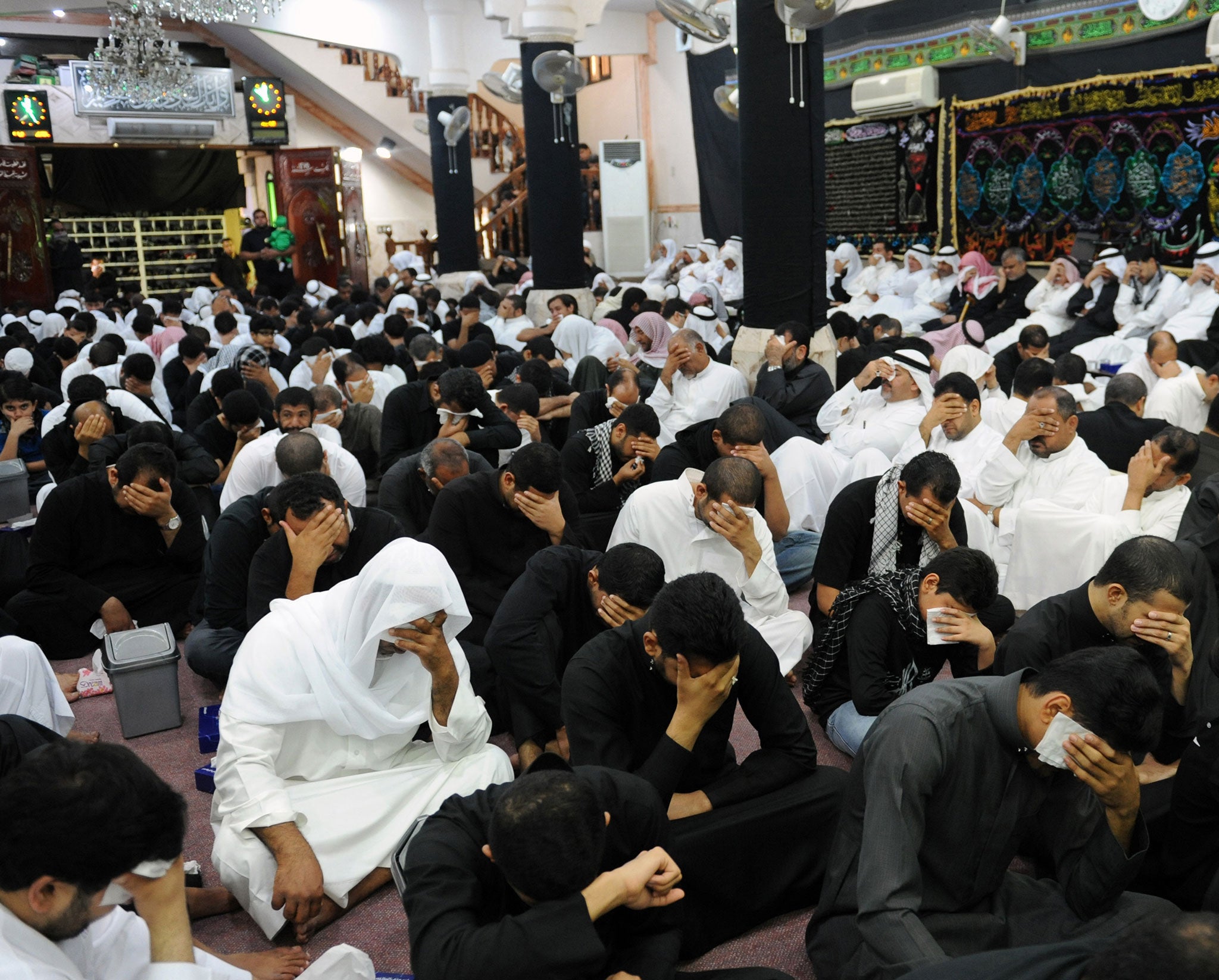 Saudi Shia Muslim men mourn during the commemoration of Ashura on 25 November, 2012, in the eastern province of Qatif