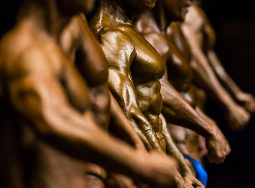 Bodybuilders flex their muscles on stage