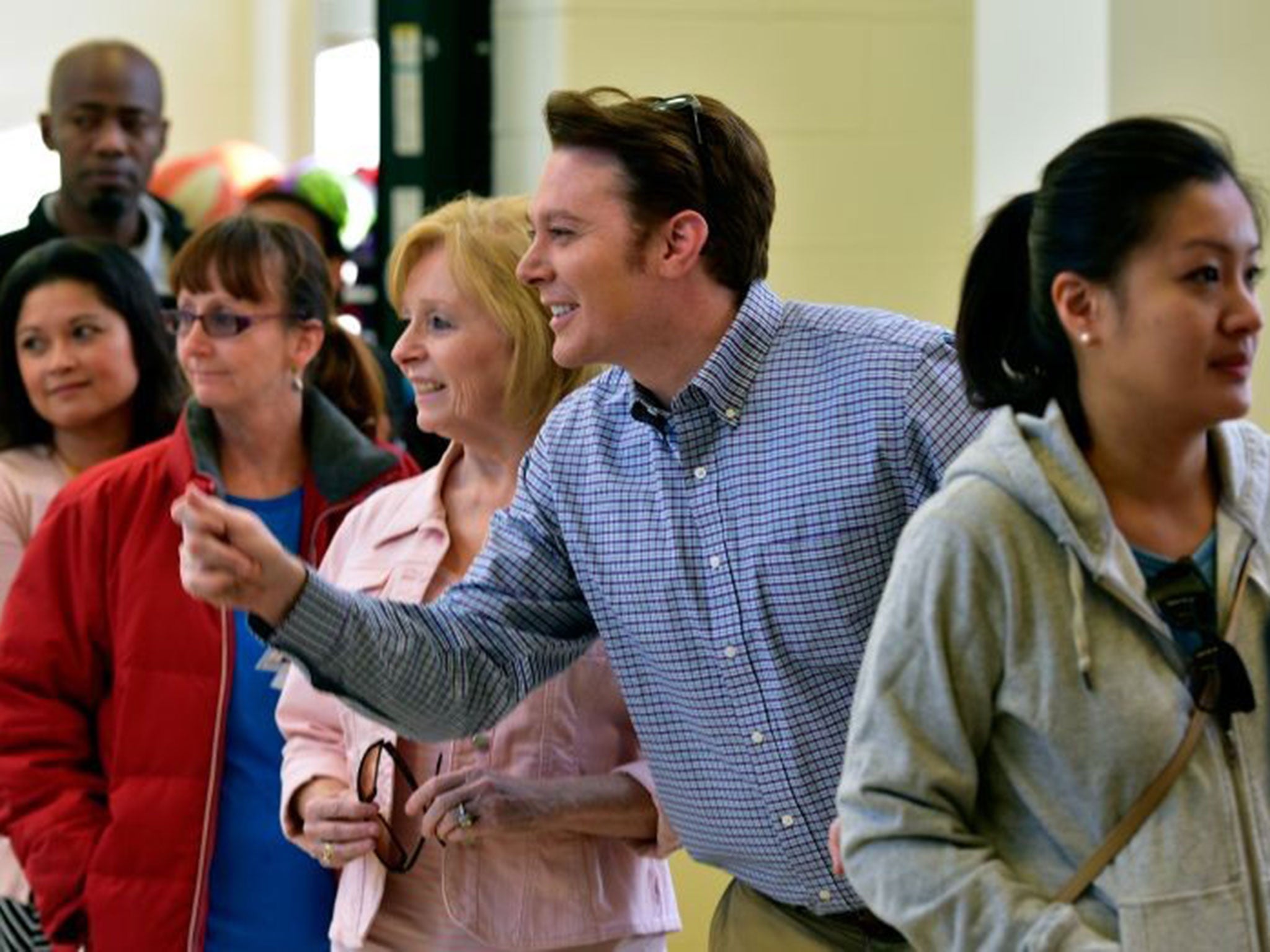 Clay Aiken, Democratic candidate for U.S. Congress in North Carolina's Second District, jokes with members of the media as he waits in line to vote