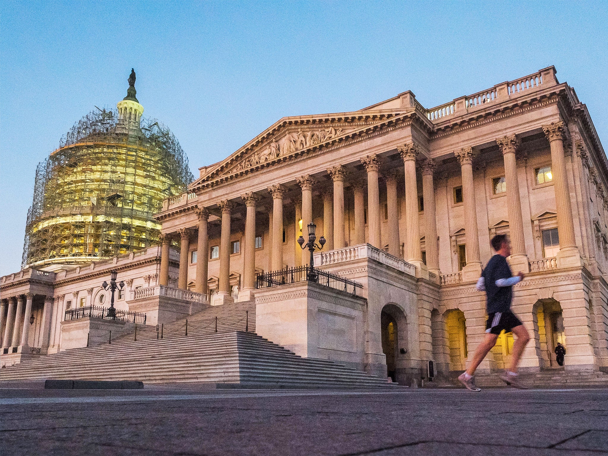A jogger runs by the Senate side of the US Capitol in Washington