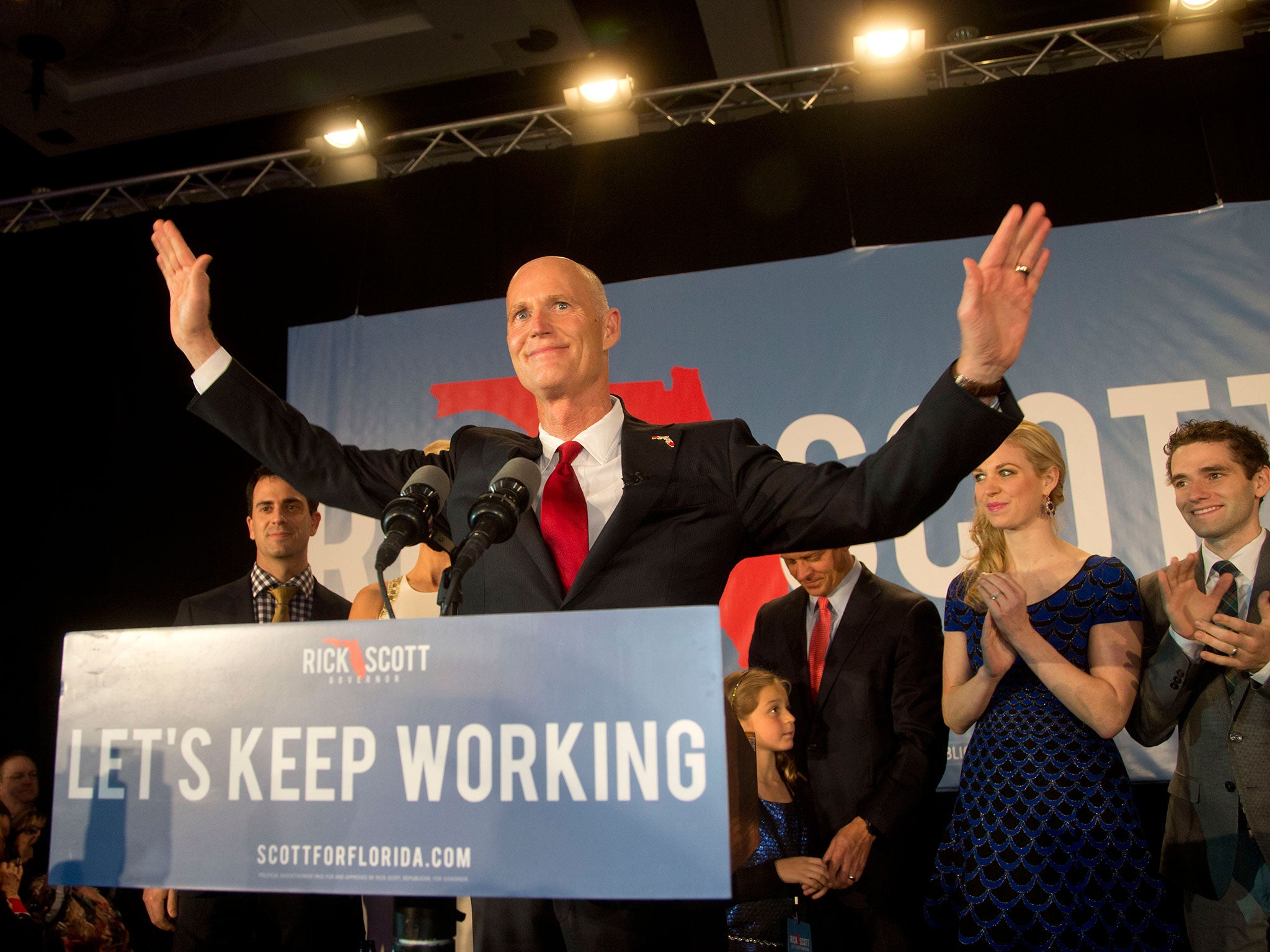 Florida Gov. Rick Scott stands at the podium before making a victory speech after defeating Democratic challenger, former Republican, Charlie Crist
