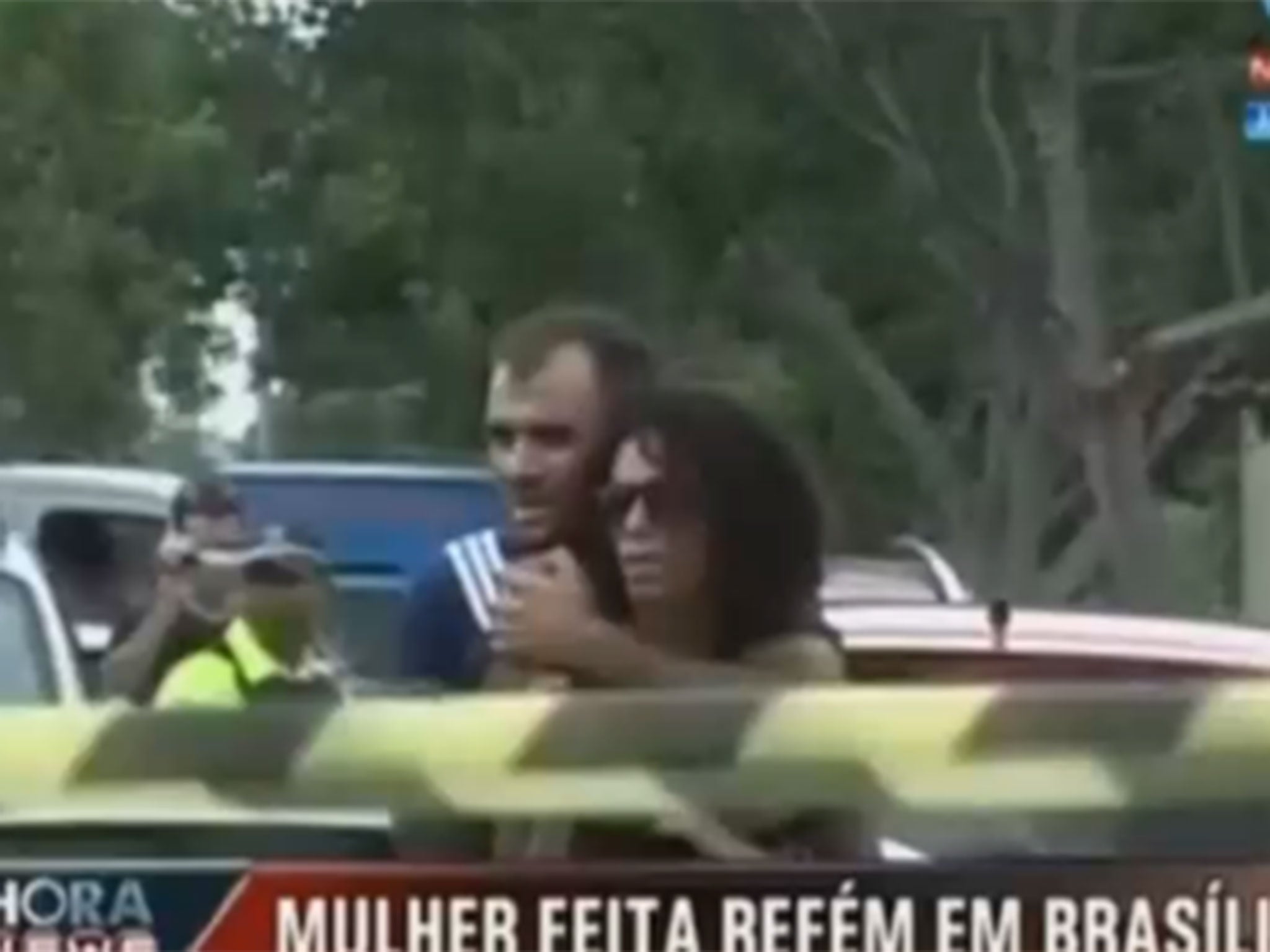 Brazilian police saved a woman in dramatic fashion after she was held hostage with two knives in the capital city of Brasilia.