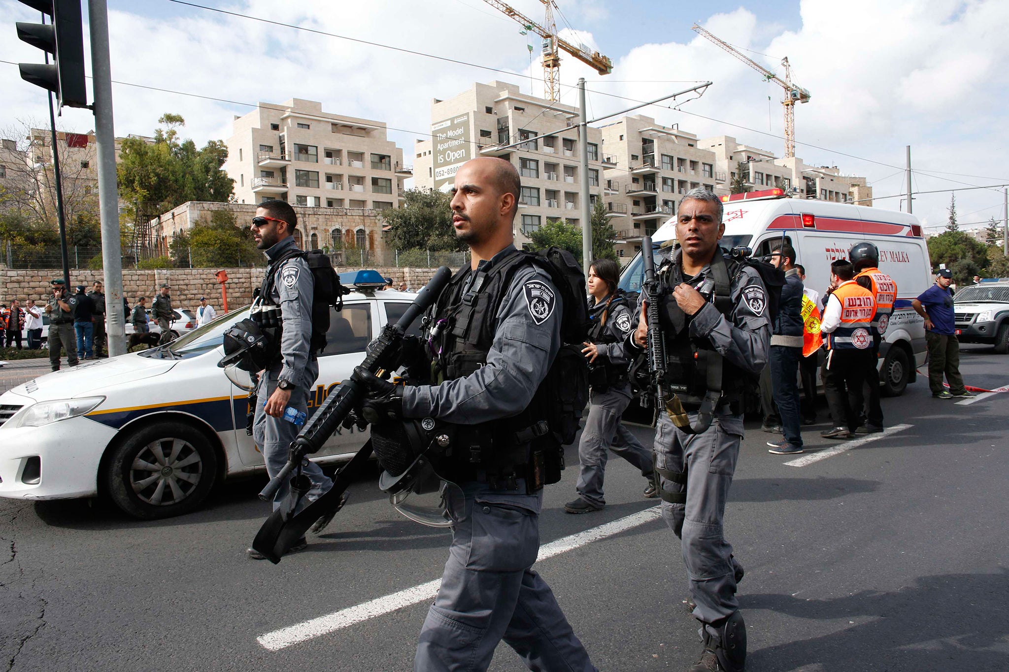 Israeli police officers walk at the scene of an attack in Jerusalem