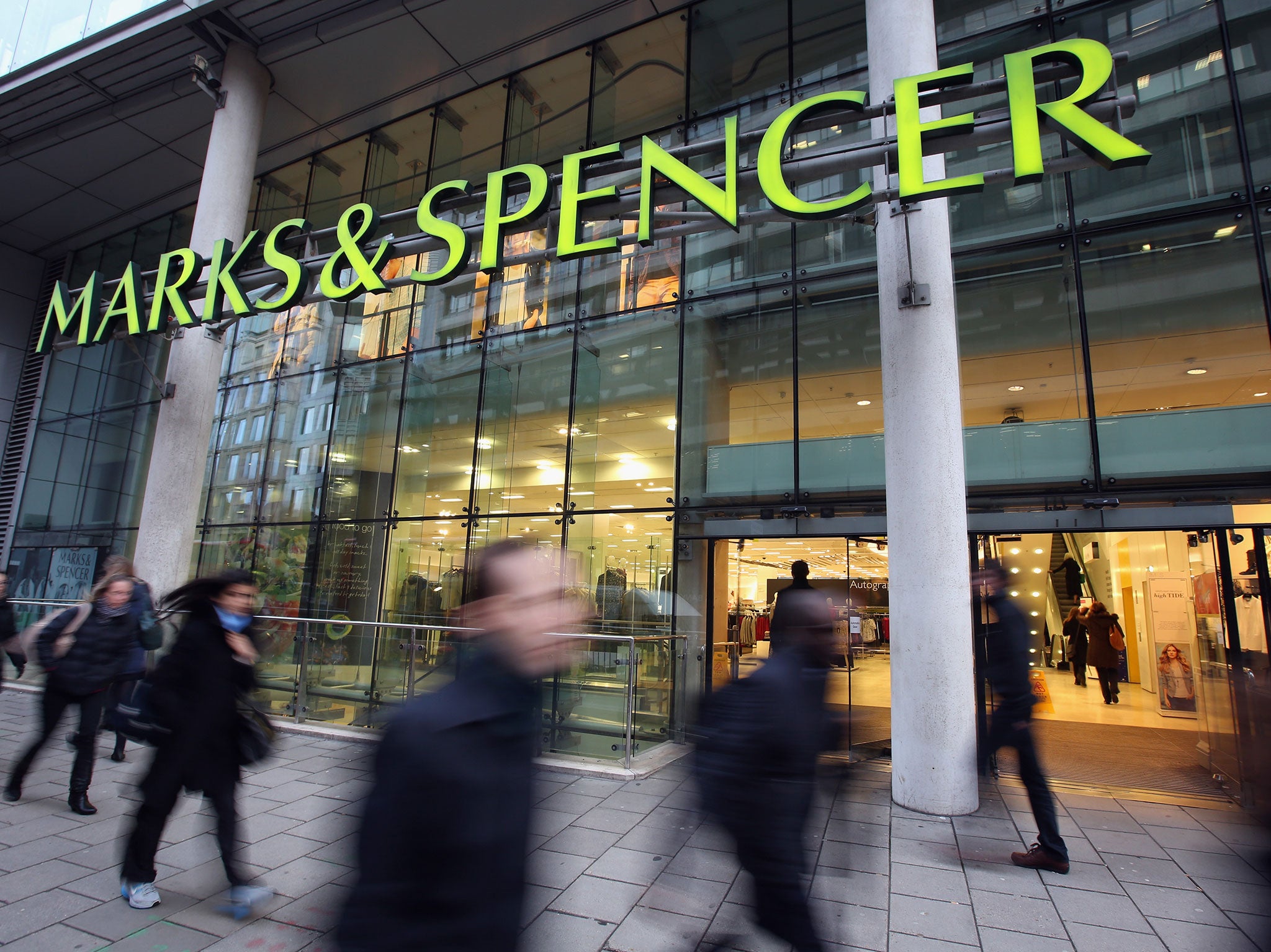 Members of the public walk past a branch of Marks & Spencer on January 7, 2014 in London, England.