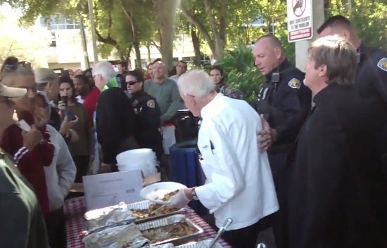 Arnold Abbott being arrested while he was serving food