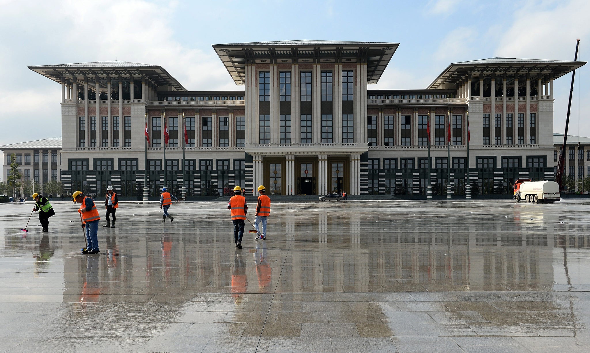 Workers clean the area in front of the new Turkish Presidential Palace prior to an official reception for Republic day in Ankara