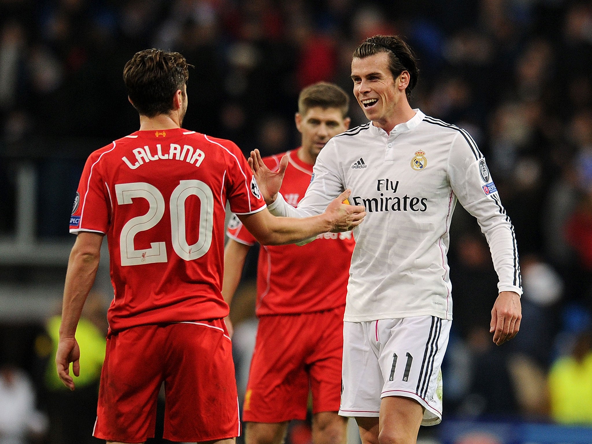 Gareth Bale (right) speaks with Adam Lallana after the match