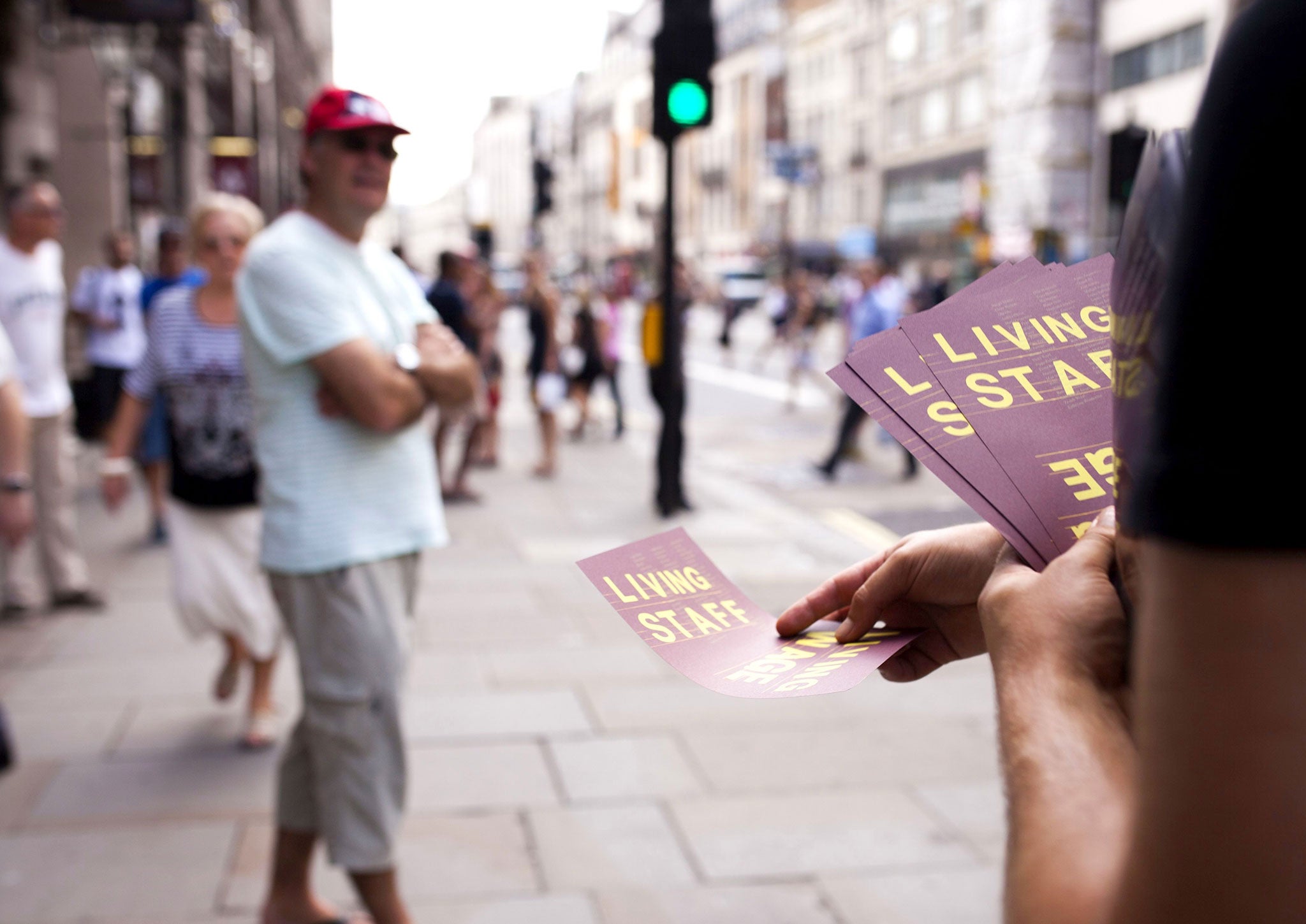 A BECTU member hands out Living Wage leaflets on a busy street in London earlier this year