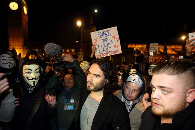 Russell Brand joins the protesters in Parliament Square during the Million Mask March on November 5, 2014 in London, England