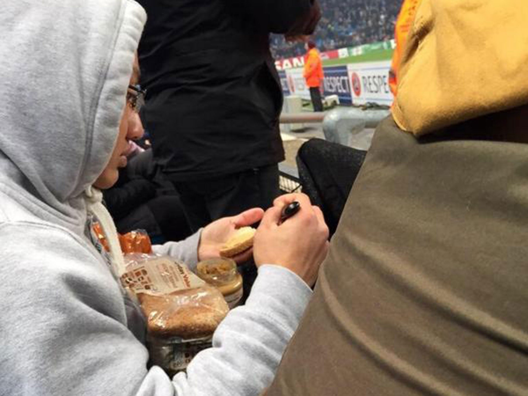 A Manchester City fan makes a peanut butter sandwich during the 2-1 defeat to CSKA Moscow