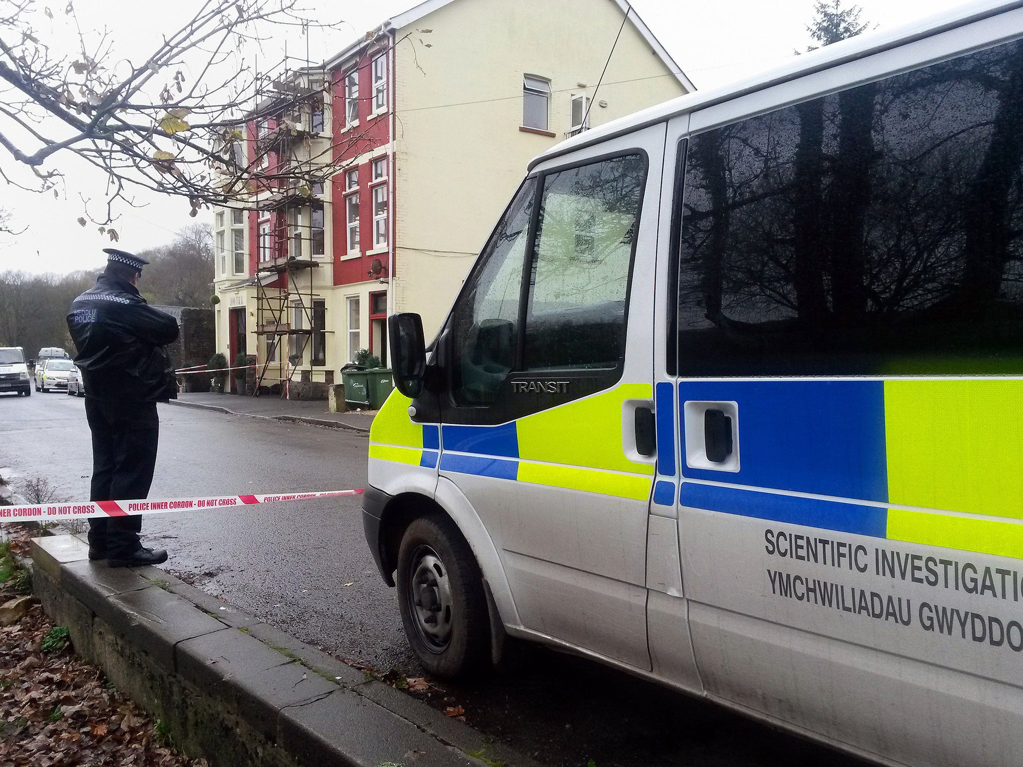 A woman has been murdered and a man has died in custody in South Wales