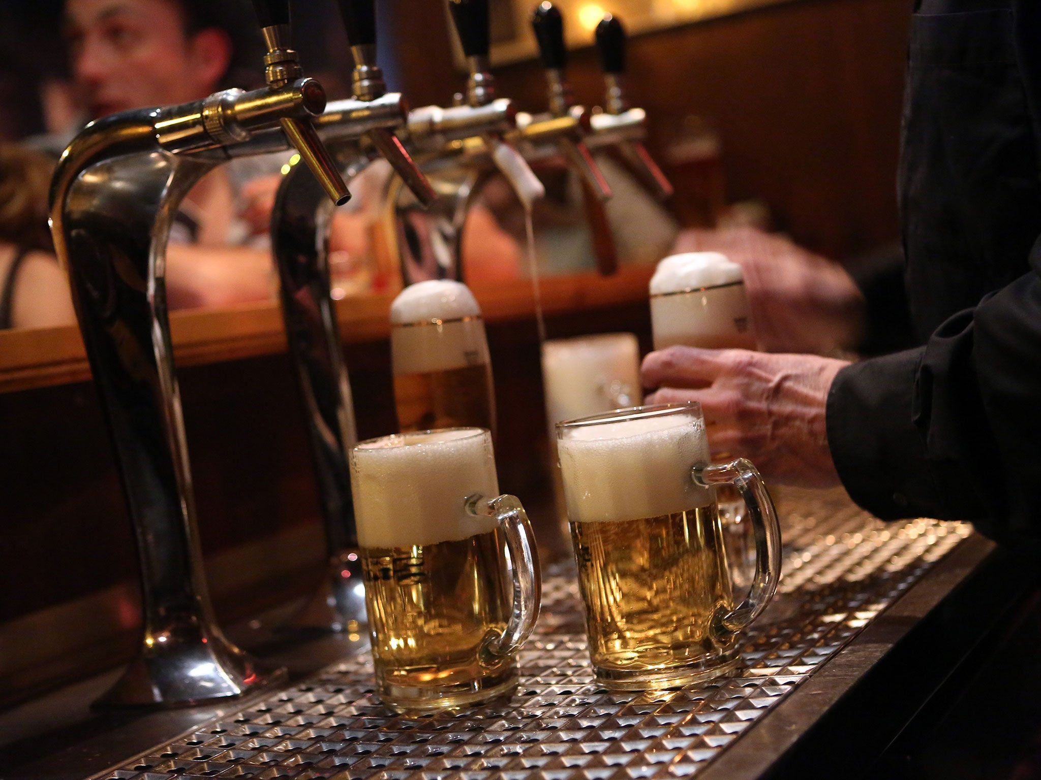 A bartender serves beers