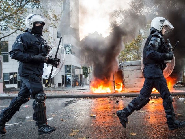 Riot policemen charge during a national trade union demonstration in Brussels