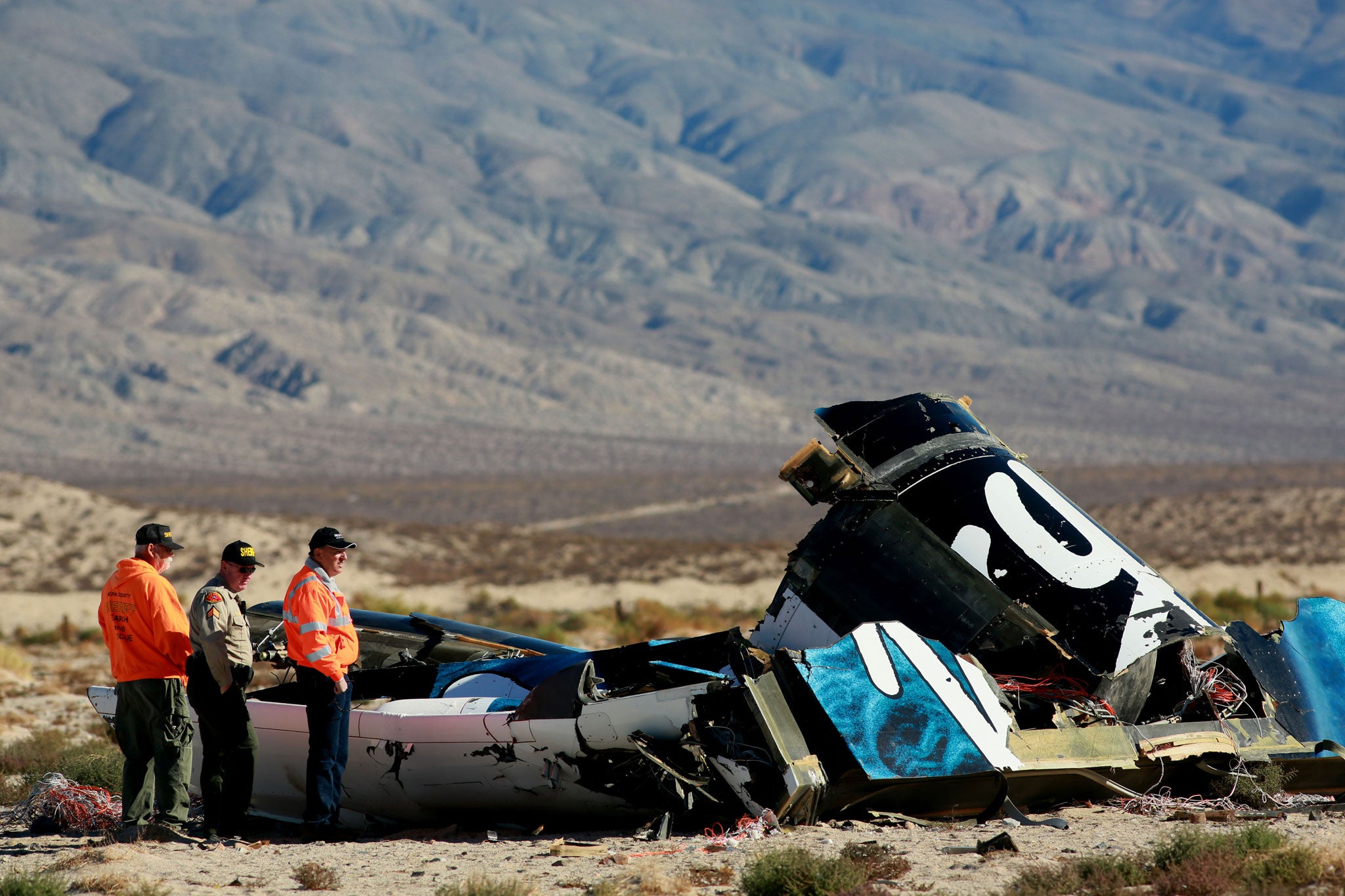 Sheriff's deputies inspect the wreckage of the Virgin Galactic SpaceShip 2 in the Mojave desert (Getty)