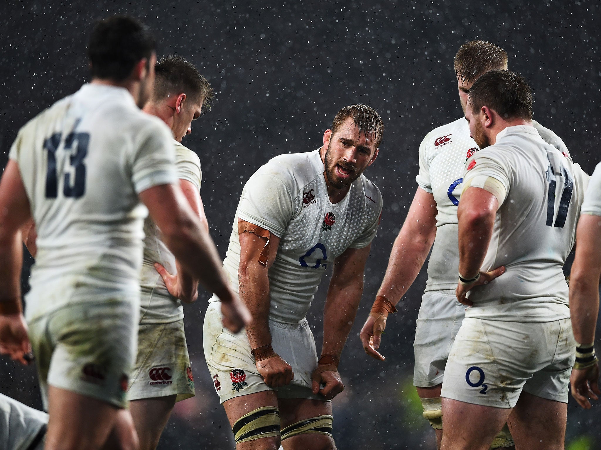 England captain Chris Robshaw stands with his team-mates in the rain at Twickenham after defeat to the All Blacks