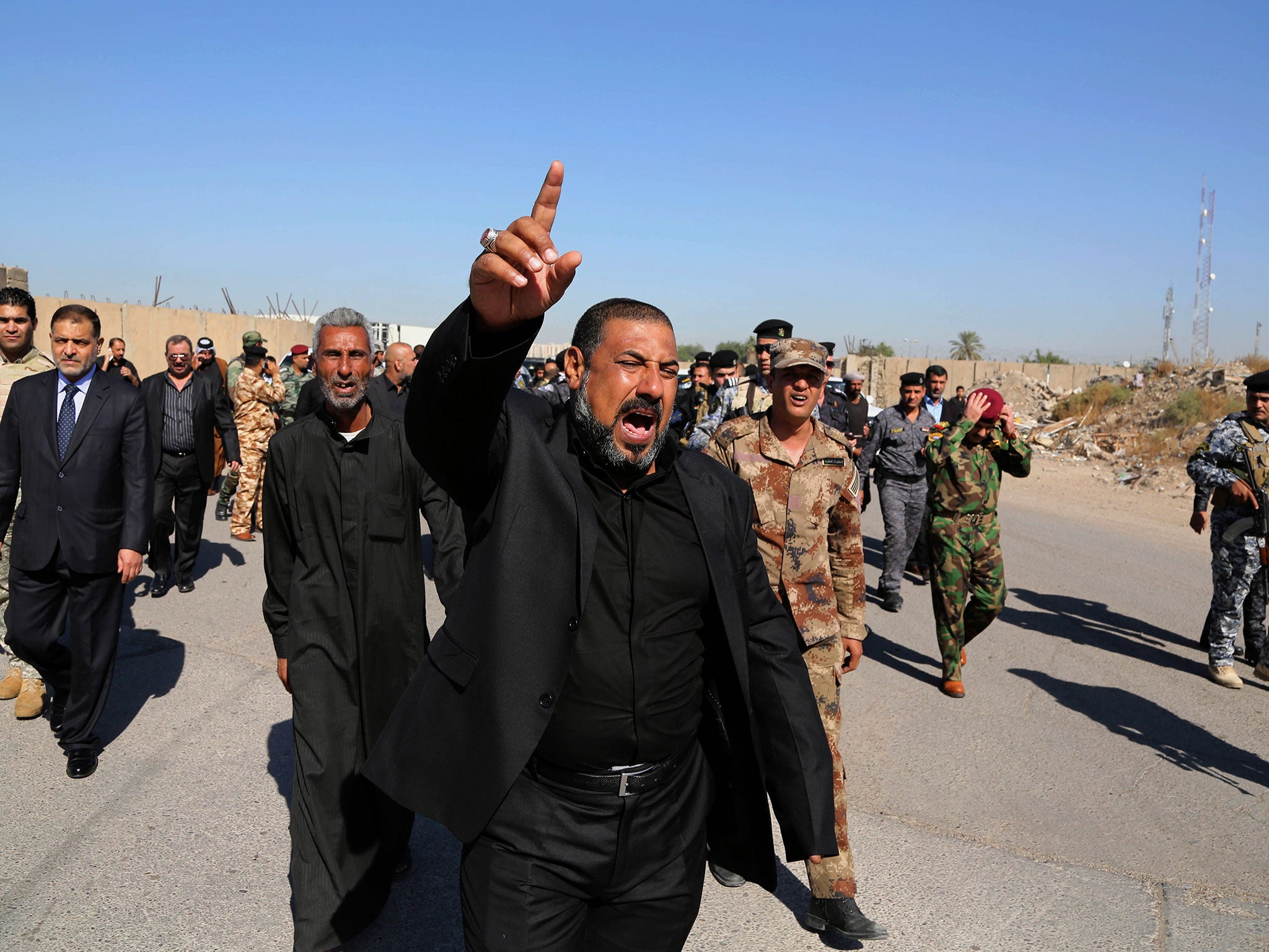 Mourners at a Baghdad funeral vent their anger against Islamic State