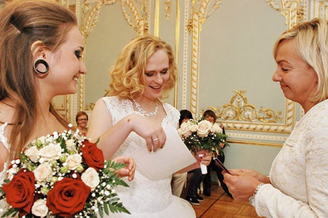 Irina Shumilova and Alyona Fursova receive their marriage certificate in the 'first Russian LGBT wedding'