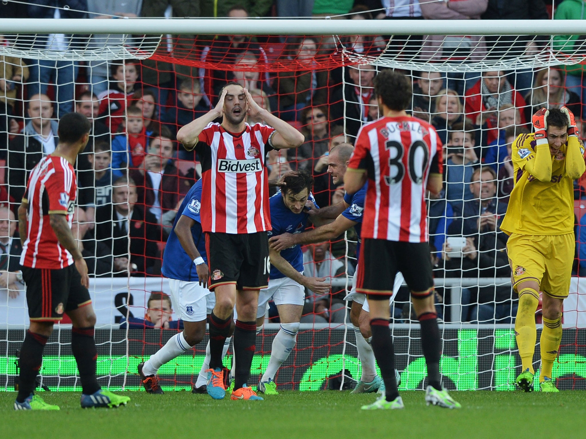 Sunderland players react as Leighton Baines of Everton (obscured centre) scores a penalty
