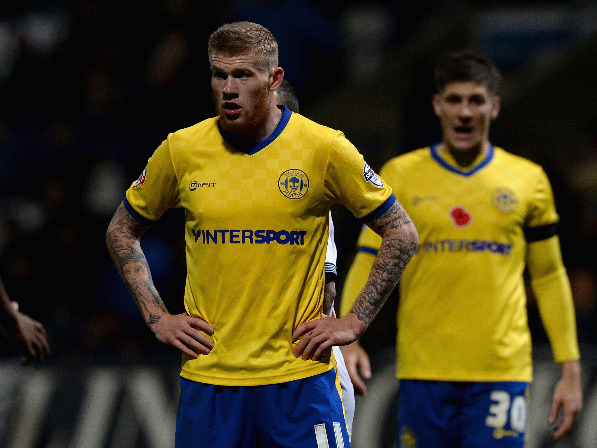 James McClean (left) in his poppy-less Wigan shirt at Bolton on Friday night