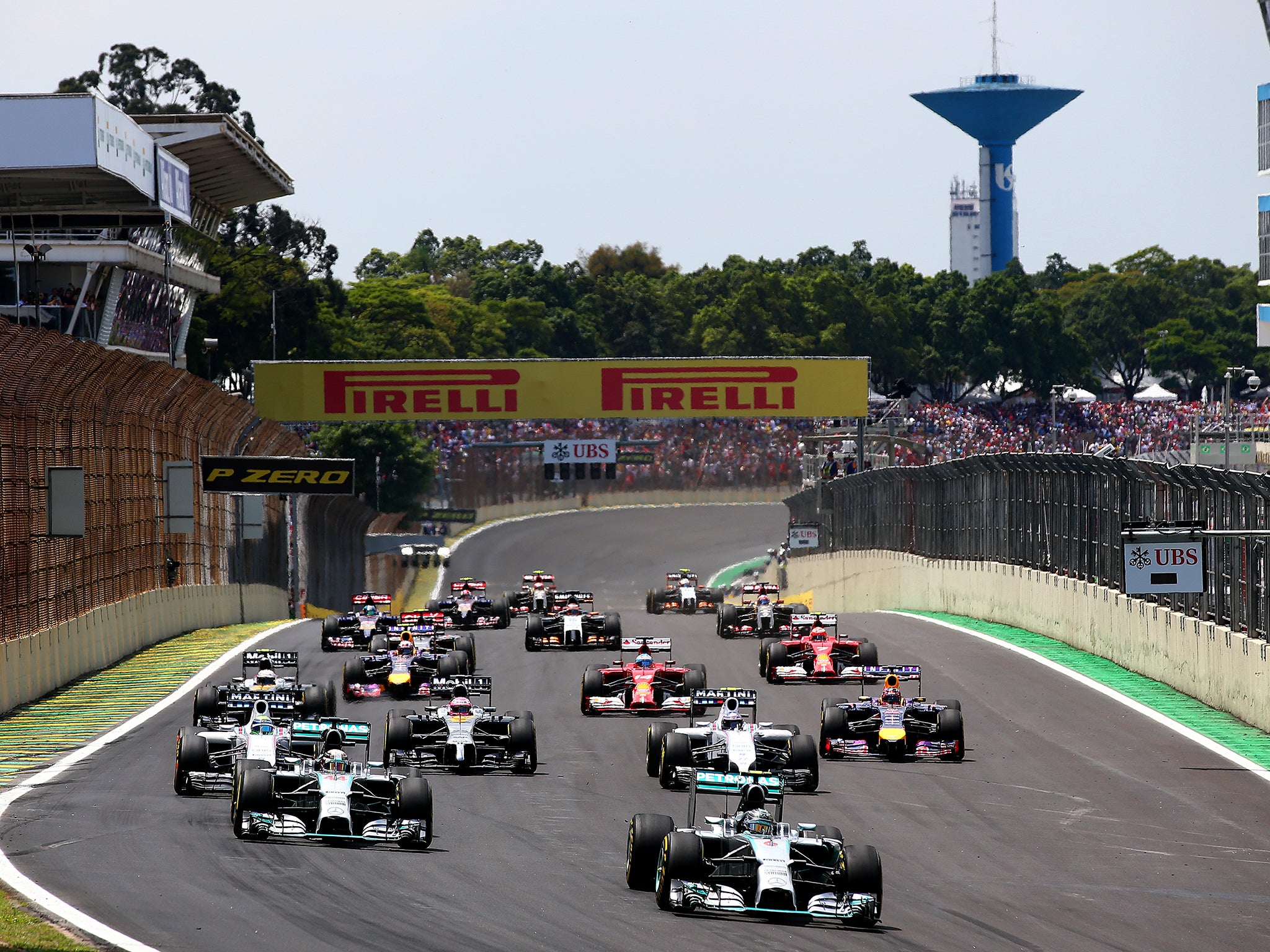 Nico Rosberg of Germany and Mercedes GP leads Lewis Hamilton of Great Britain and the field during the Brazilian Formula One Grand Prix
