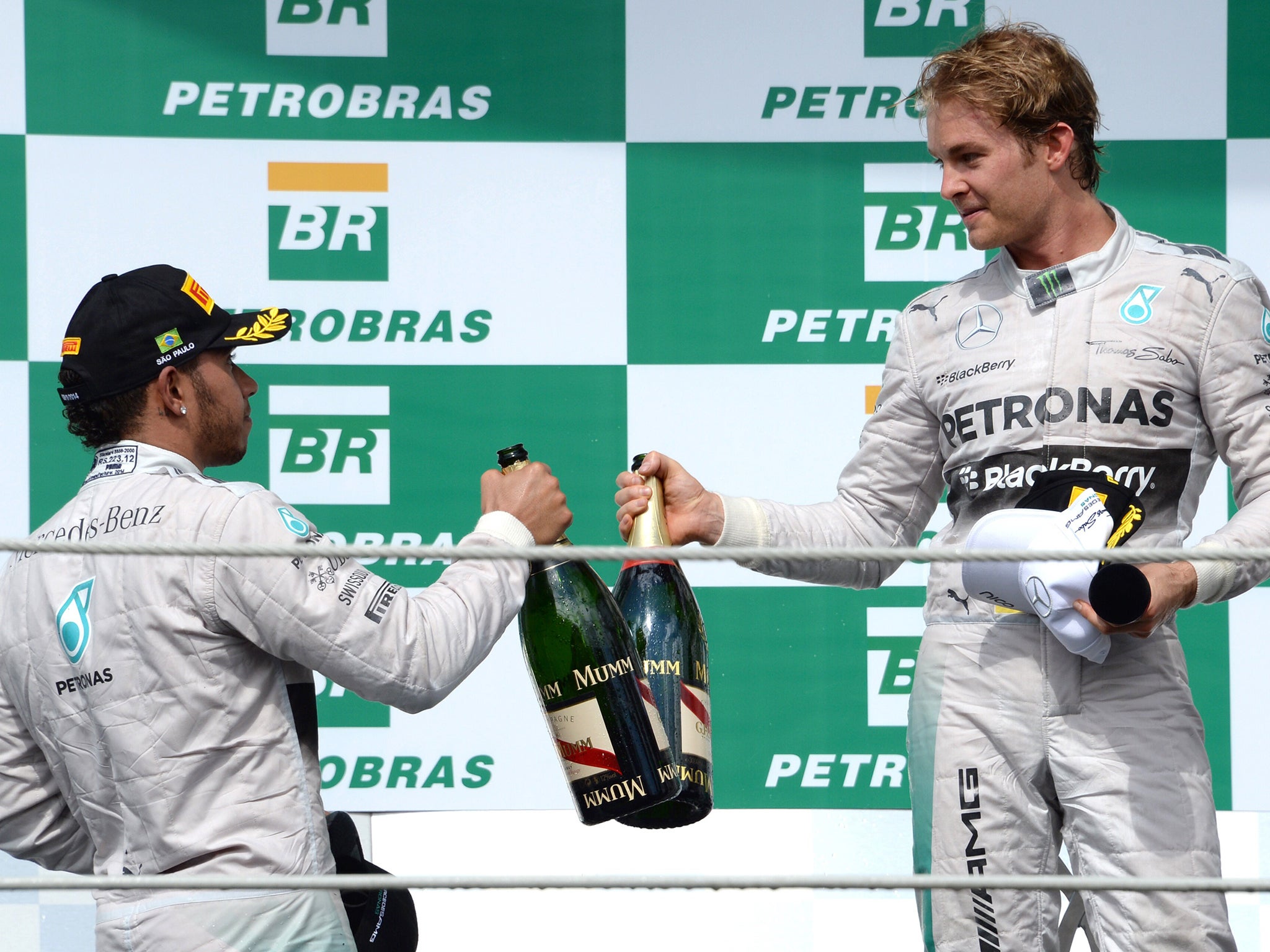 Mercedes AMG Petronas German driver Nico Rosberg (R) celebrates on the podium with teammate Lewis Hamilton