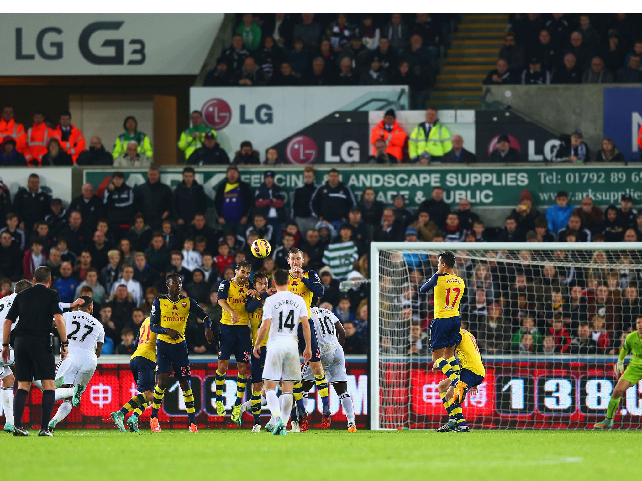 Gylfi Sigurdsson (far left) curls in a remarkable free-kick