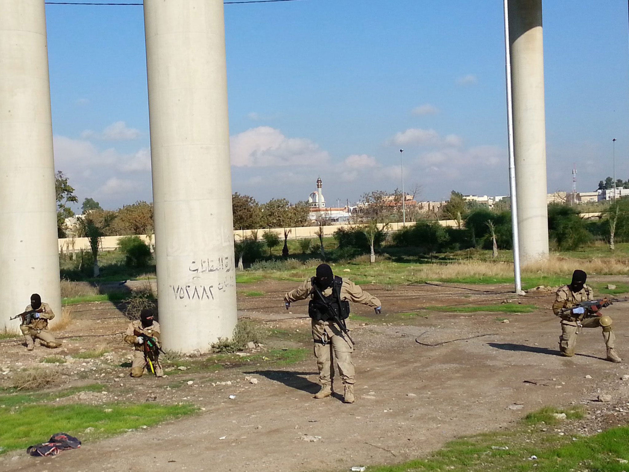 Isis fighters take part in military training in Mosul