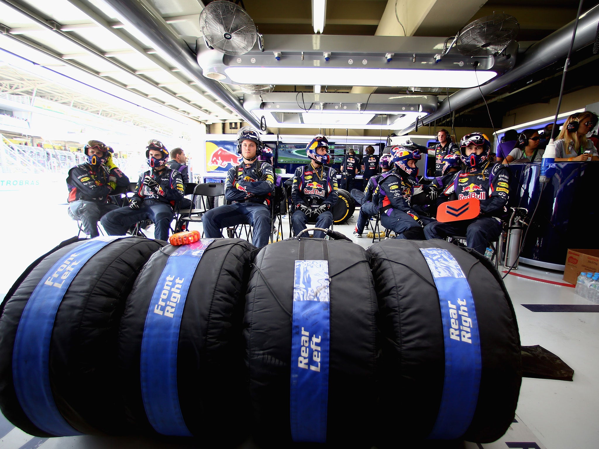 The Red Bull mechanics await their drivers with the tyres at the ready