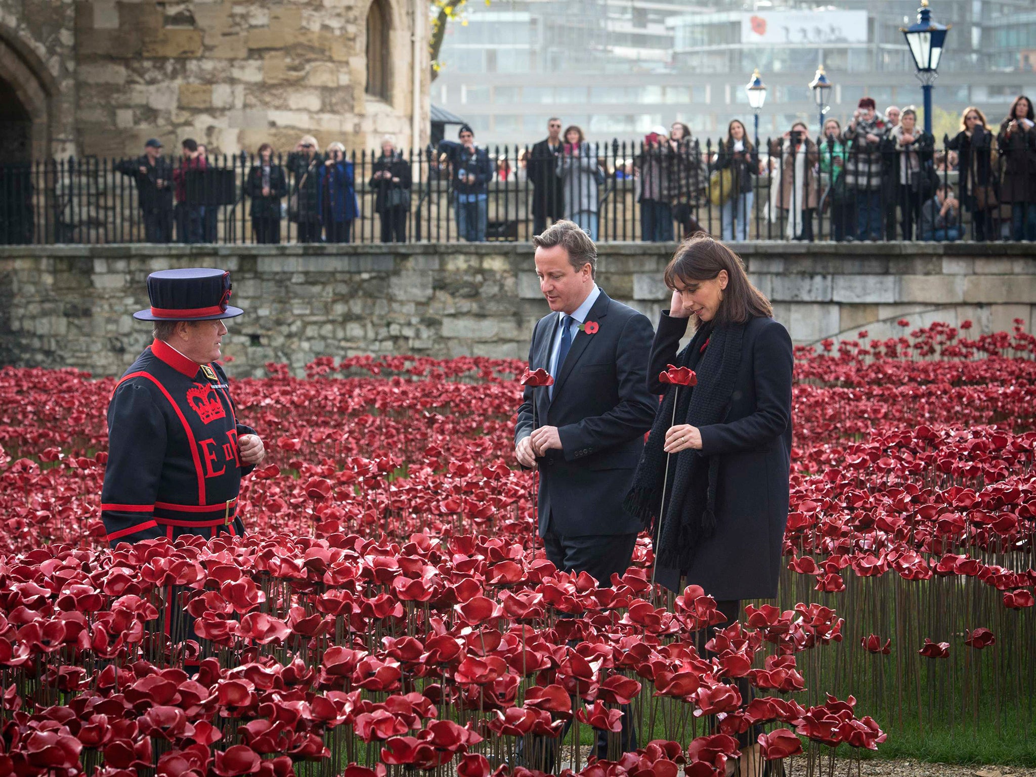 Prime Minister David Cameron and his wife Samantha each lay a poppy at an art installation, at the Tower of London