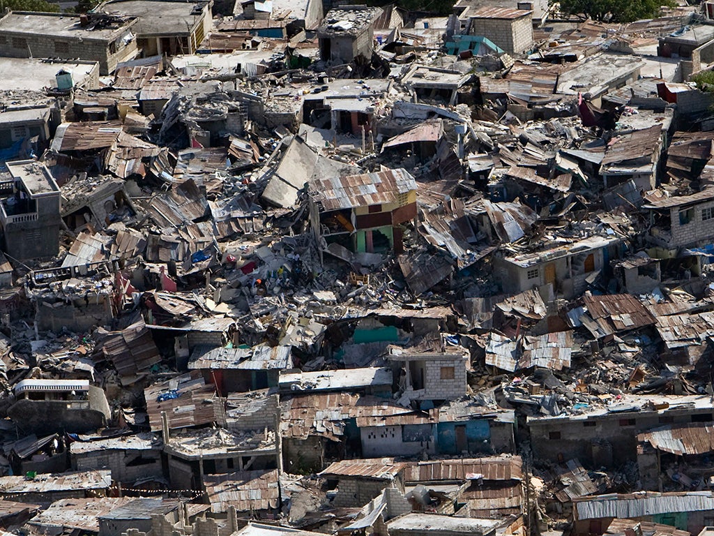 Houses in a poor neighborhood sit destroyed after an earthquake on January 13, 2010 in Port-au-Prince, Haiti
