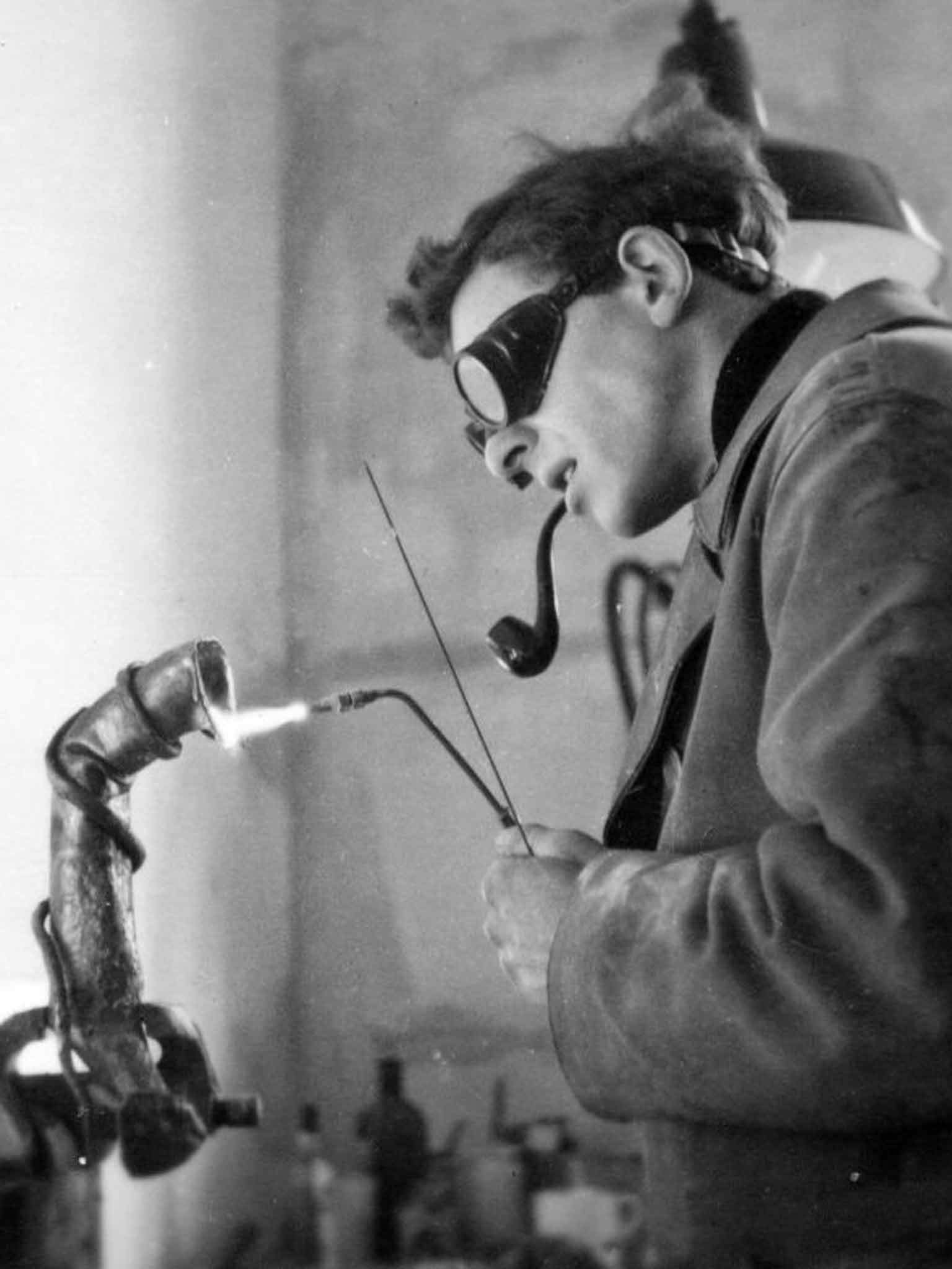 Clarke at work in 1955 welding the piece 'Symbol'