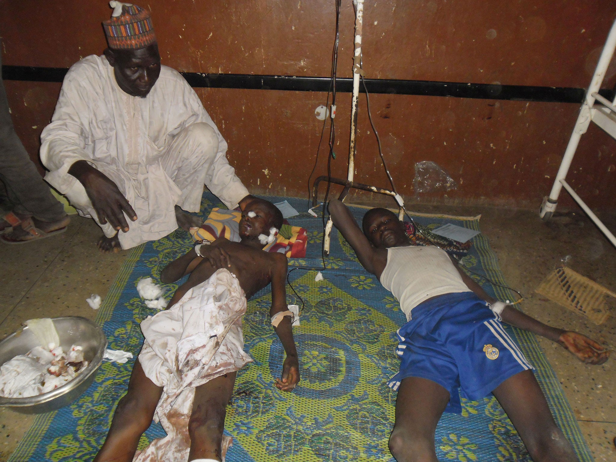 People are treated at the General hospital in Potiskum, Nigeria, following a suicide bomb attack at Government Science Technical College