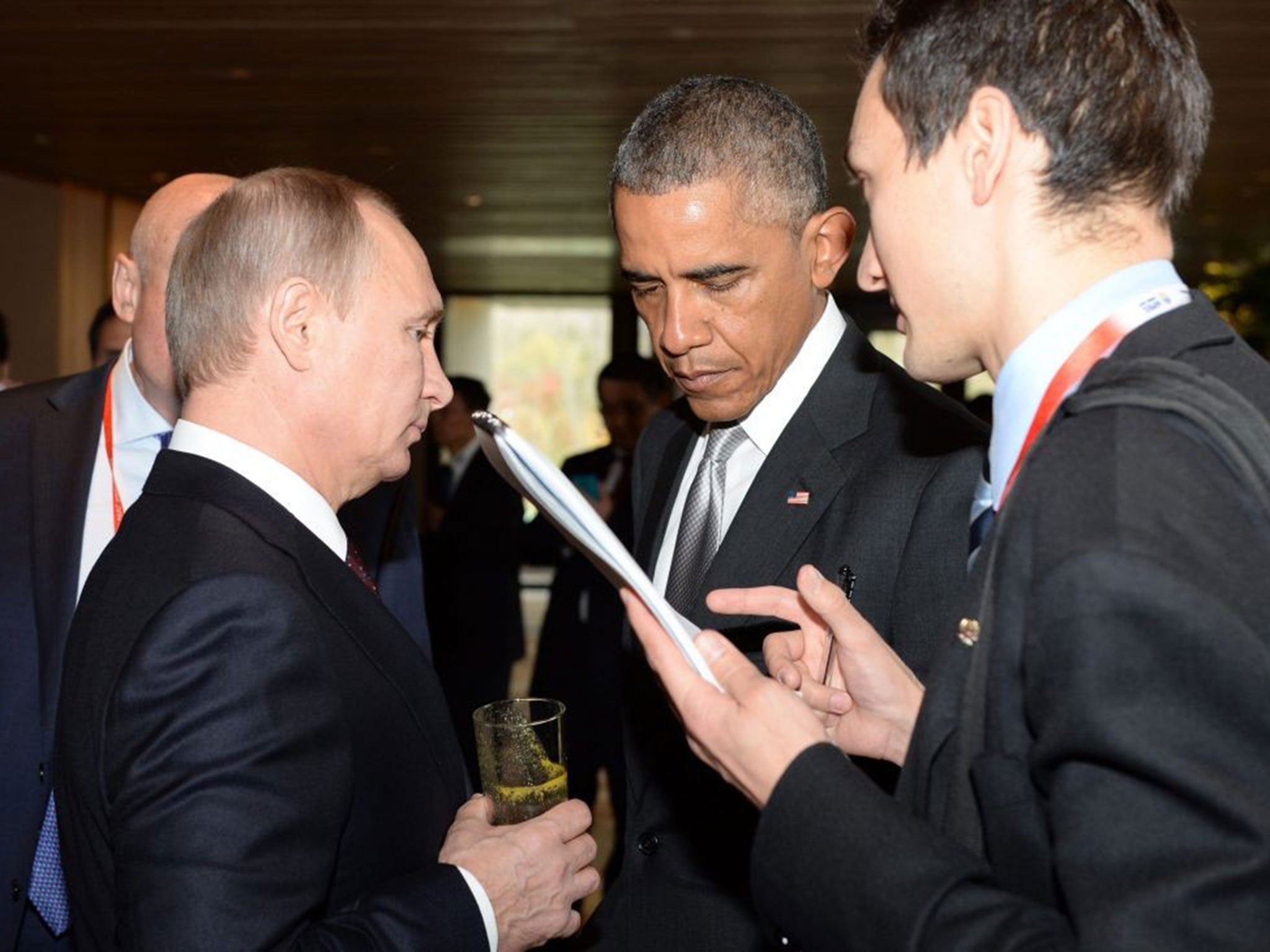Vladimir Putin speaks with US President Barack Obama during the Apec summit in November, 2014
