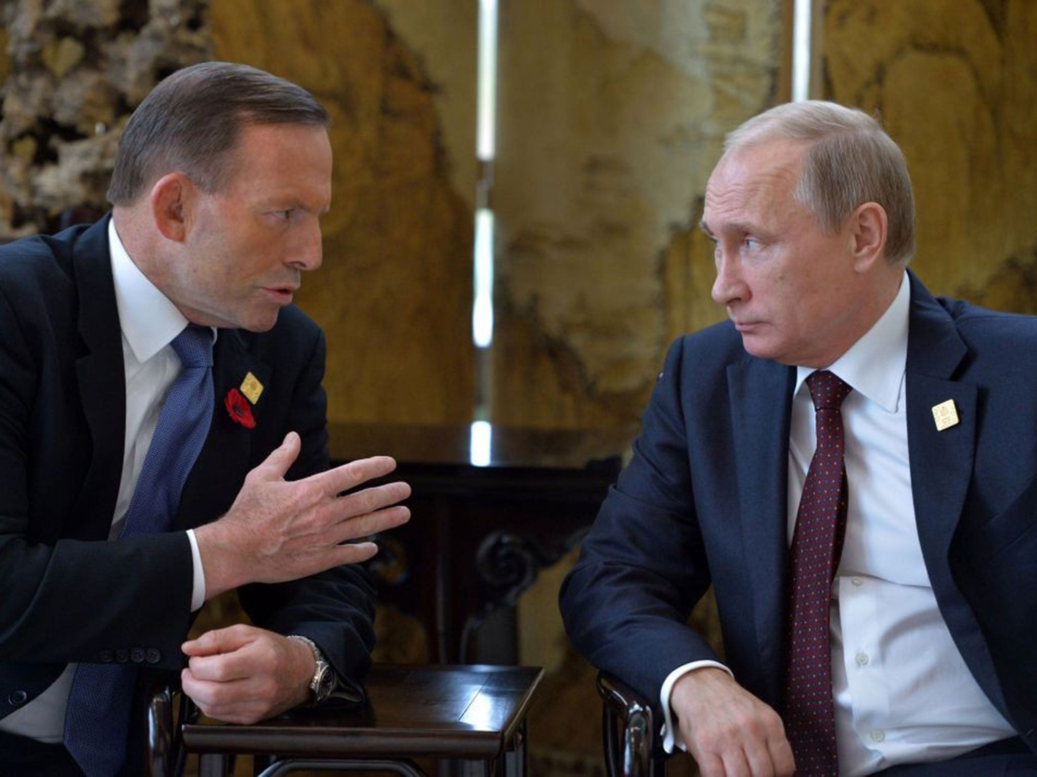 Russian President Vladimir Putin, right, and Australian Prime Minister Tony Abbott talk on the sidelines of the Asia-Pacific Economic Cooperation (APEC) Summit in Beijing
