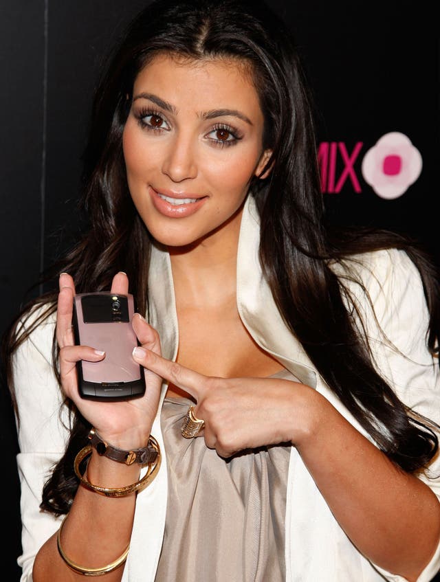 Television personality Kim Kardashian poses next to a BlackBerry 8330 Pink Curve xxclusively on August 27, 2008 