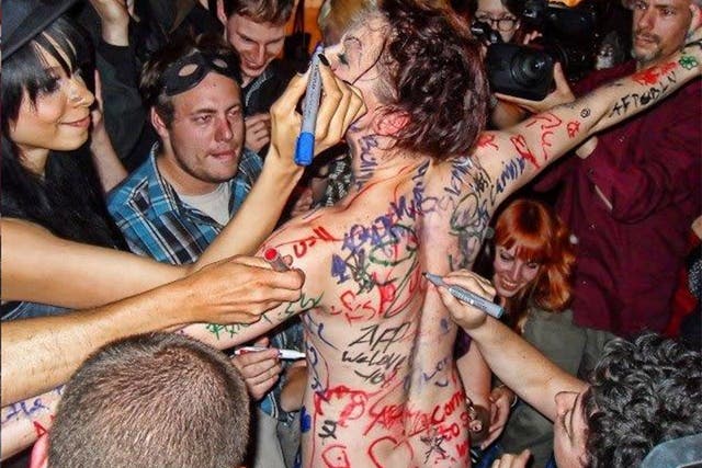 Write stuff: Amanda Palmer at a performance in Berlin, 2012, where she stripped off and invited the crowd to scribble on her