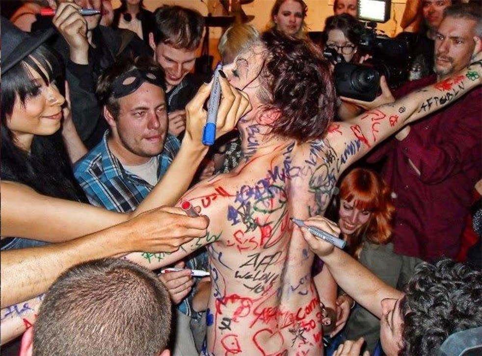 Write stuff: Amanda Palmer at a performance in Berlin, 2012, where she stripped off and invited the crowd to scribble on her