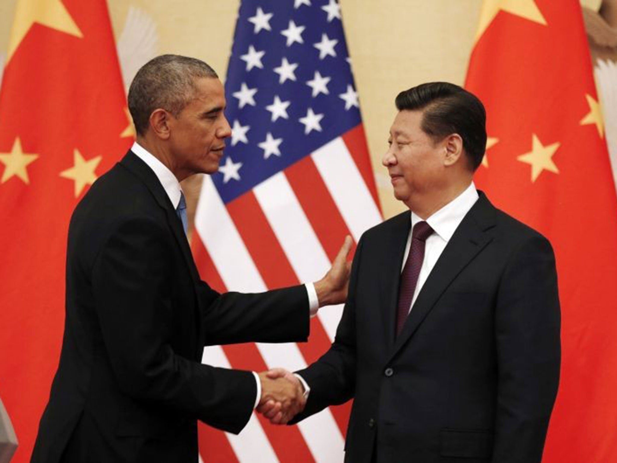 U.S. President Barack Obama (L) and Chinese President Xi Jinping shake hands at the end of their news conference in the Great Hall of the People in Beijing November 12, 2014.