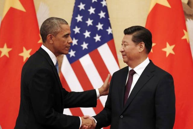 U.S. President Barack Obama (L) and Chinese President Xi Jinping shake hands at the end of their news conference in the Great Hall of the People in Beijing November 12, 2014. 