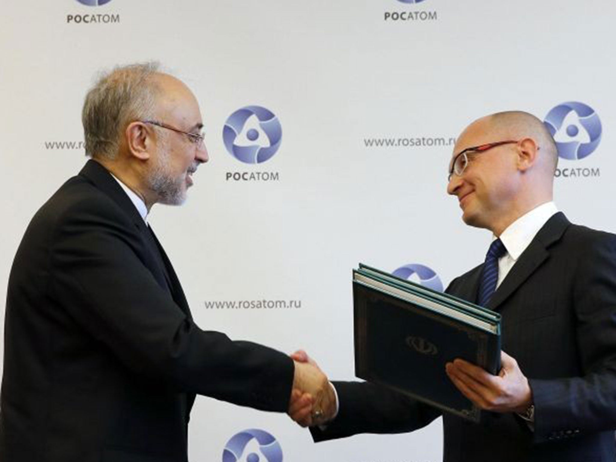 Sergei Kiriyenko and Ali Akbar Salehi shake hands during a signing ceremony in Moscow on a new nuclear deal