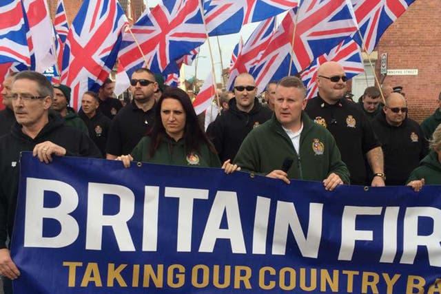 <p>Britain First marching at a rally - Jayda Fransen, in green, can be seen with party leader Paul Golding at the front</p>